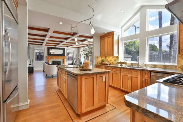 a kitchen with stainless steel appliances kitchen island granite countertop a stove and cabinets