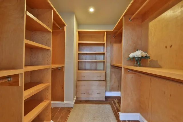 a view of walk in closet with empty racks