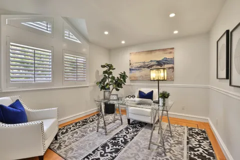 a spacious bedroom with a bed and a chandelier