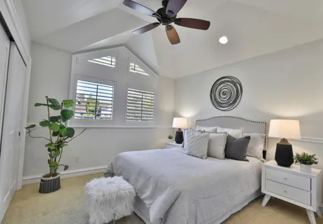 a bedroom with a bed and a table in it