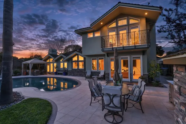 a front view of a house with cars parked