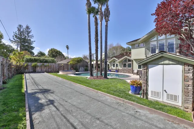 a view of a house with swimming pool and sitting area