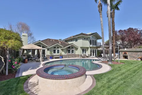 a backyard of a house with barbeque oven