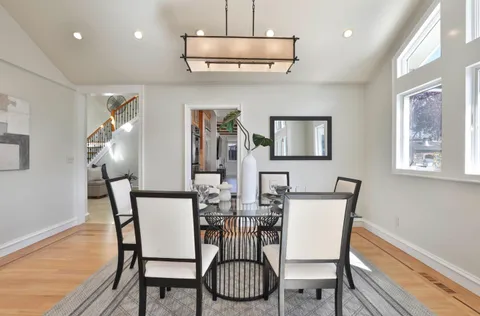 a view of a dining room with furniture wooden floor and chandelier