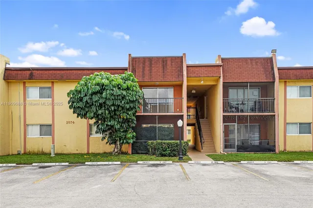a house that has a tree in front of it