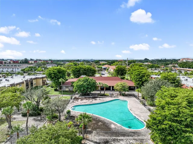 an aerial view of residential houses with outdoor space and street view