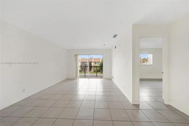 a view of an empty room with windows