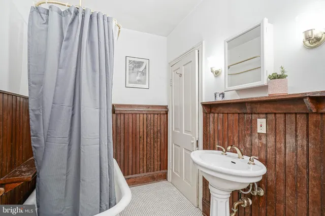 a bathroom with a sink a mirror and a window