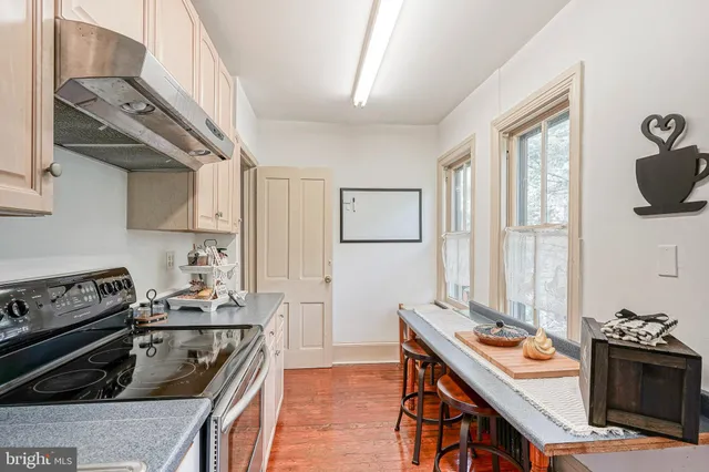 a kitchen with a stove and a refrigerator