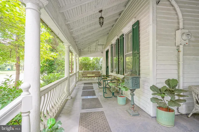 a view of a porch with furniture and garden