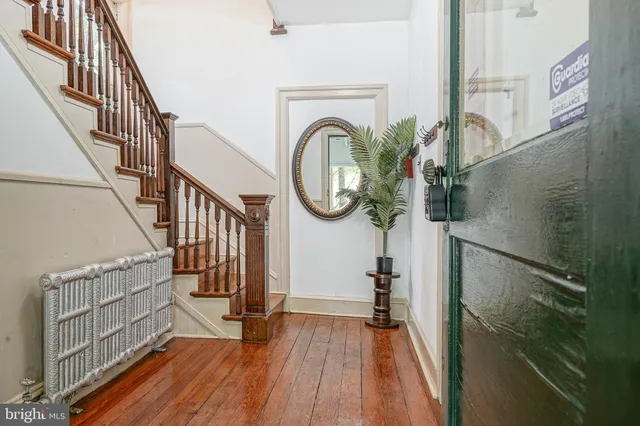 a view of staircase with railing and a chandelier