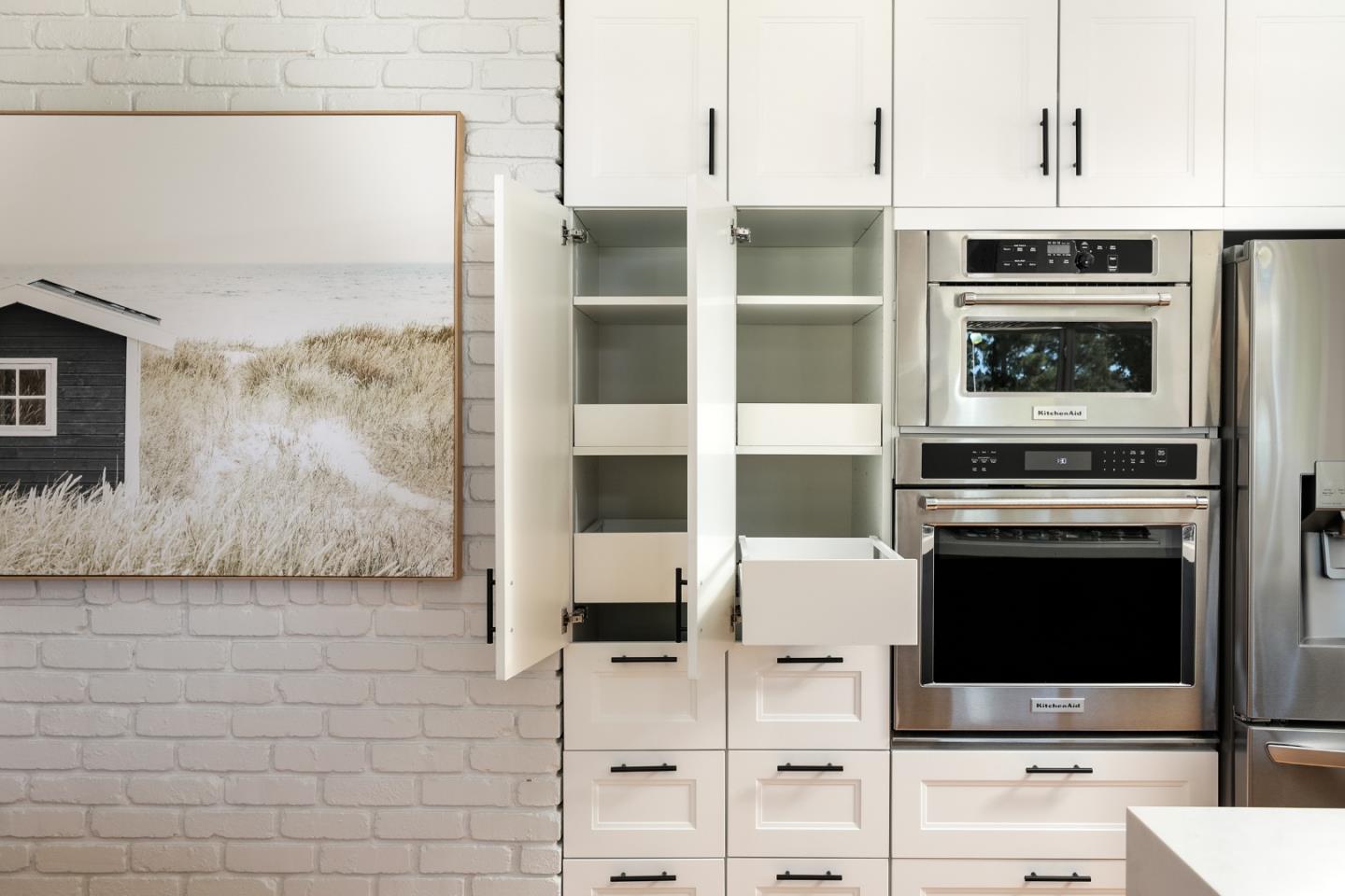 147 Lakeshore Drive San Mateo, CA 94402 - Photo 10 of 36 a kitchen with granite countertop a stove and a microwave