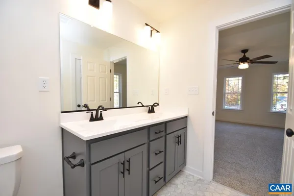 a bathroom with 2 sink and a mirror