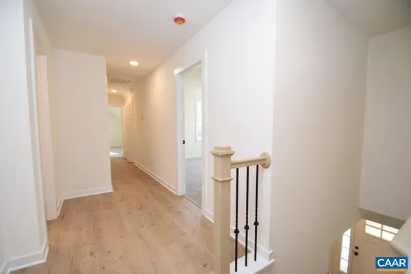 a view of hallway with stairs and a closet