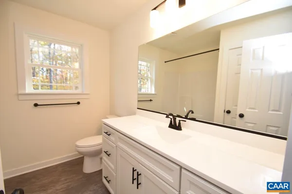 a bathroom with a sink toilet and vanity