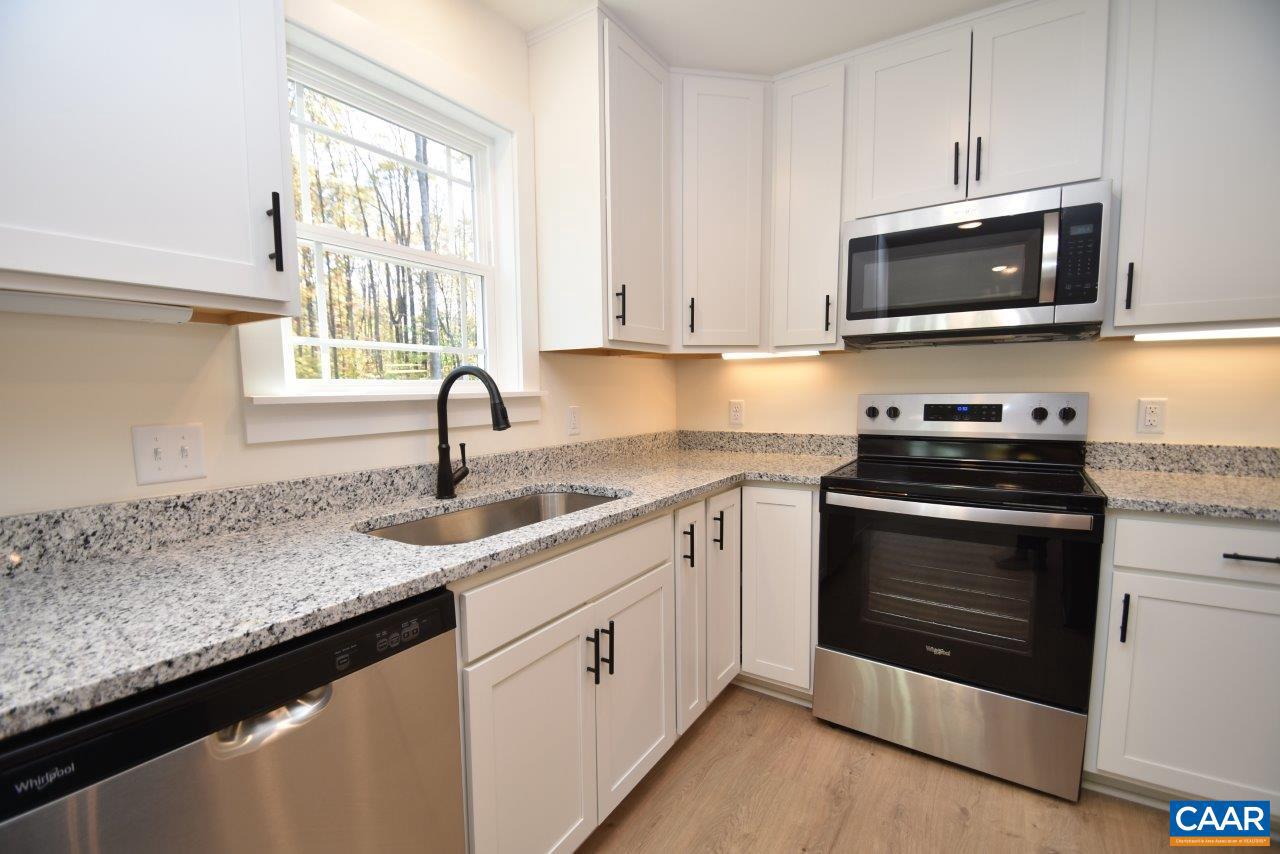 5 Bacon Bit Lane Louisa, VA 23093 - Photo 8 of 27 a kitchen with granite countertop a sink and a stove top oven with dishwasher