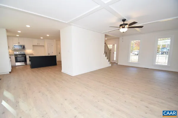 a view of an empty room with window and cabinet