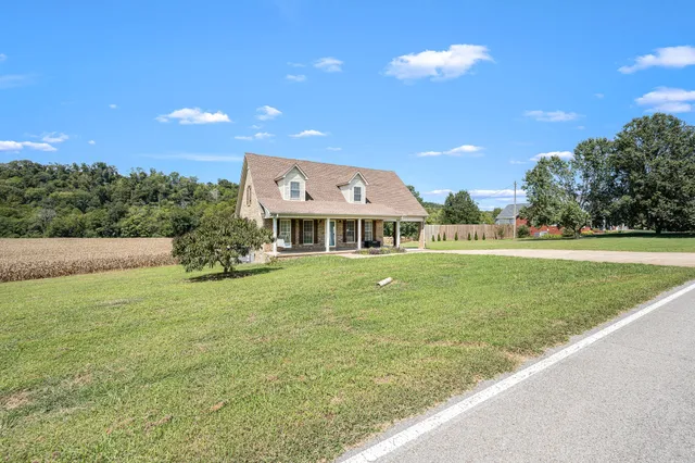 a view of a terrace with yard and mountain view in back