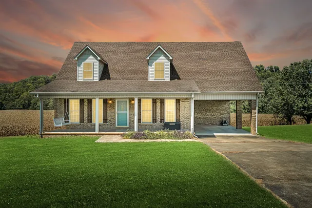 a front view of house with yard and green space
