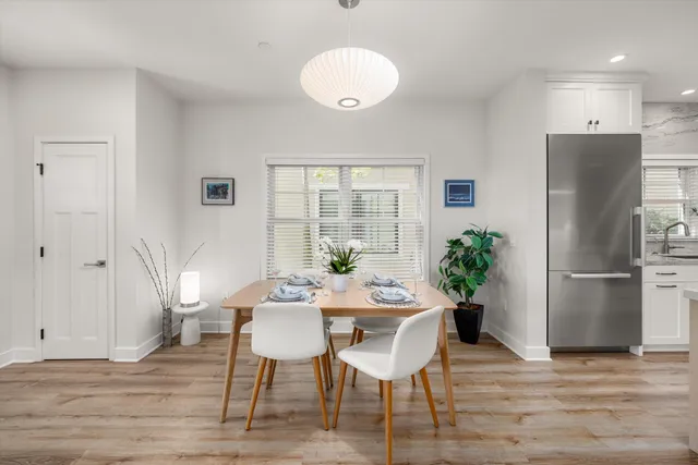 a view of a dining room with furniture window and wooden floor