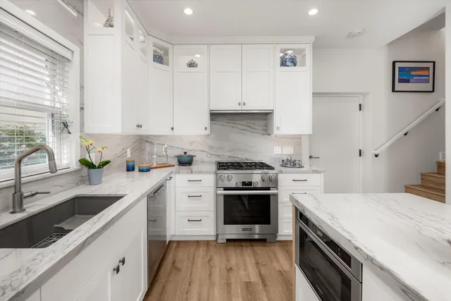 a kitchen with a sink stove and cabinets