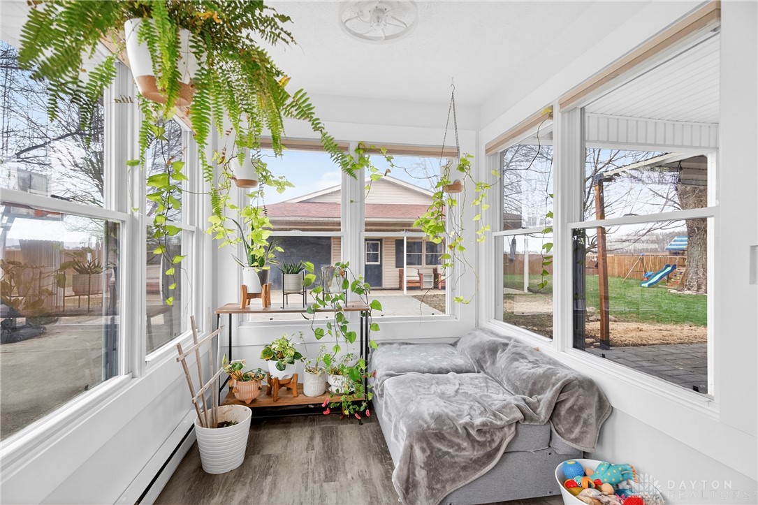 7888 Darke-Preble County Line Road Arcanum, OH 45304 - Photo 22 of 51 This bright sunroom with expansive windows provides a delightful space for relaxation and indoor gardening.