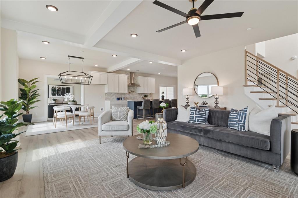 a living room with fireplace furniture and a chandelier