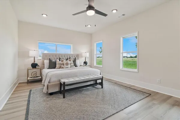 a bedroom with a bed chandelier and window