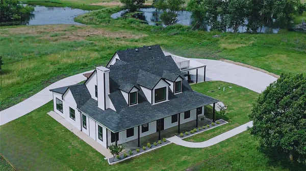 a aerial view of a house with a yard