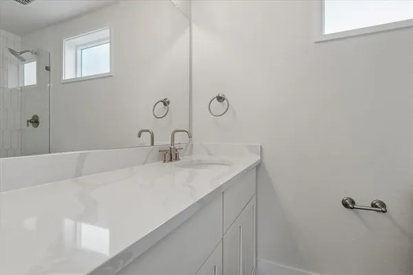 a bathroom with a sink and vanity