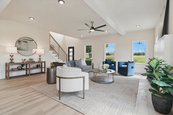 a living room with furniture a chandelier and a potted plant