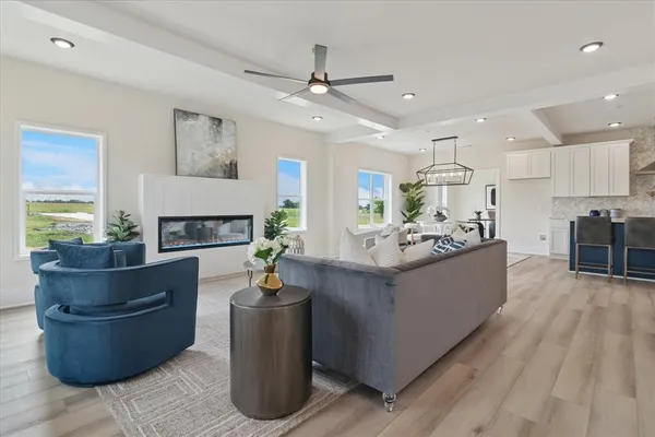 a living room with stainless steel appliances kitchen island furniture and a fireplace