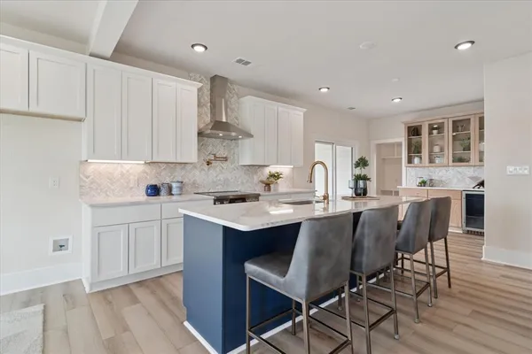 a kitchen with appliances a sink a counter top space and cabinets