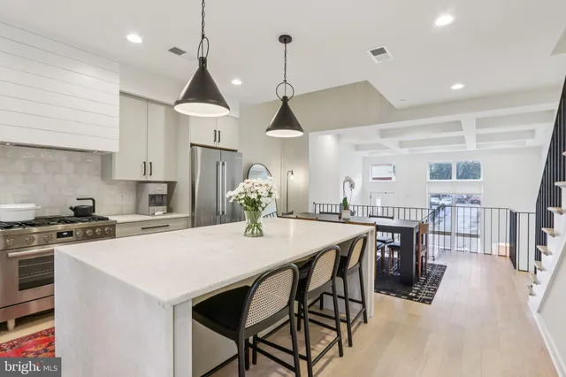 a kitchen with cabinets appliances a sink and a counter top space