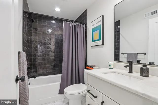 a bedroom with a large bed and a potted plant