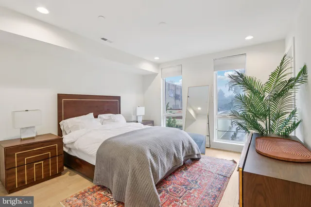 a bedroom with a large bed and a large window