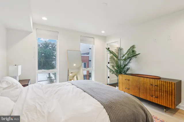 a bedroom with a bed and a potted plant