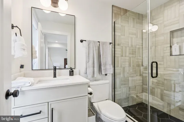 a view of staircase with railing and white walls