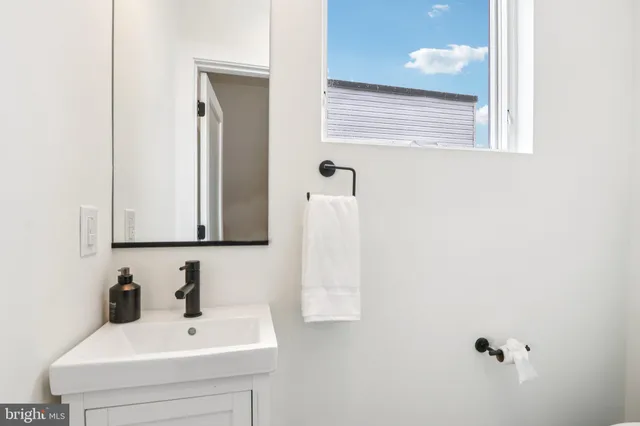 a white toilet sitting next to a white sink