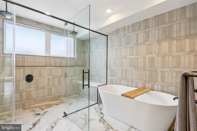 a white bath tub sitting in a bathroom next to a sink