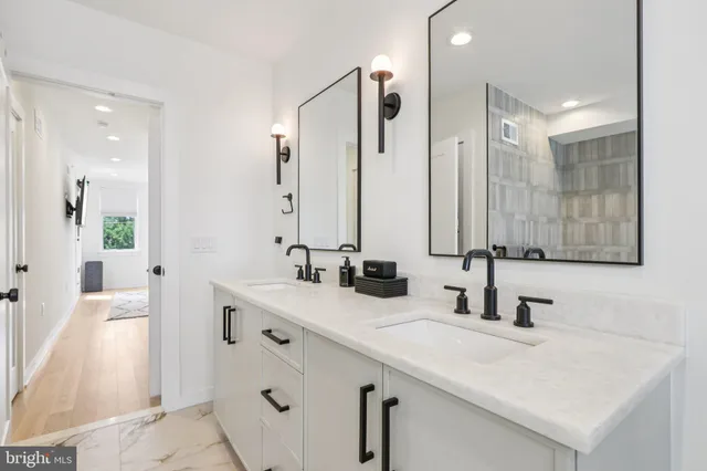 a white toilet sitting next to a white wall