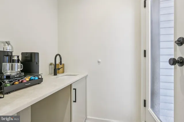 a view of roof deck with couches and potted plants
