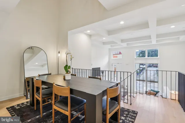 a dining room with furniture a rug and wooden floor