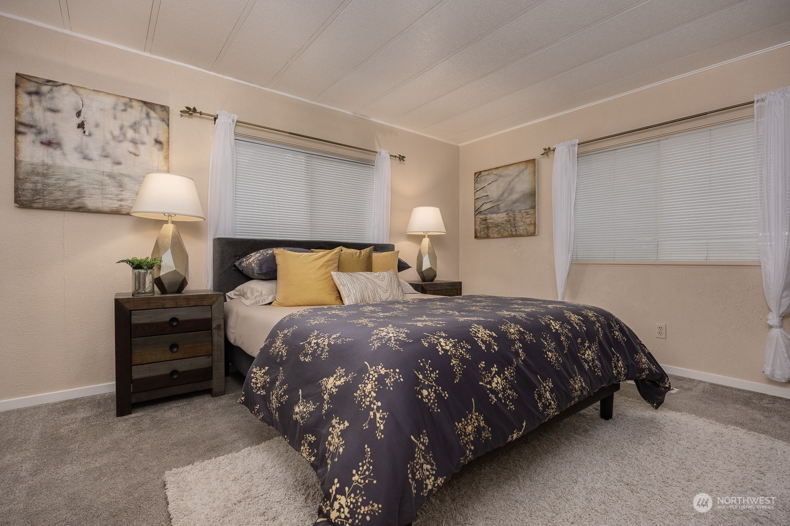 201 Union Avenue Southeast, Unit 131 Renton, WA 98059 - Photo 12 of 24 a bedroom with a bed and a night stand