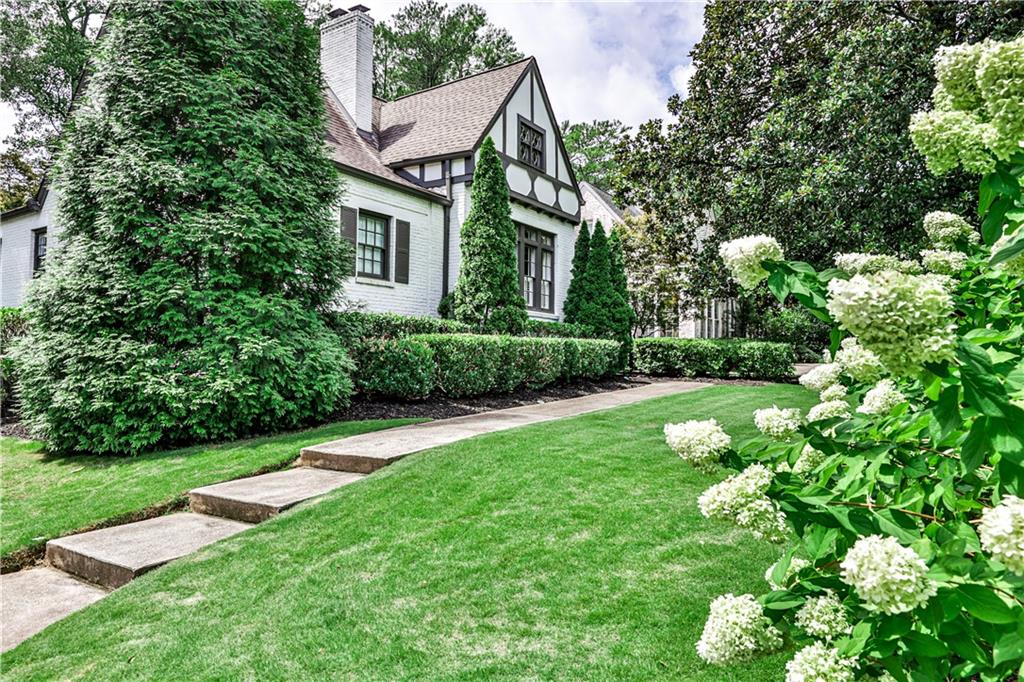 1689 Johnson Road Northeast Atlanta, GA 30306 - Photo 1 of 1 a view of a house with a yard and flower plants
