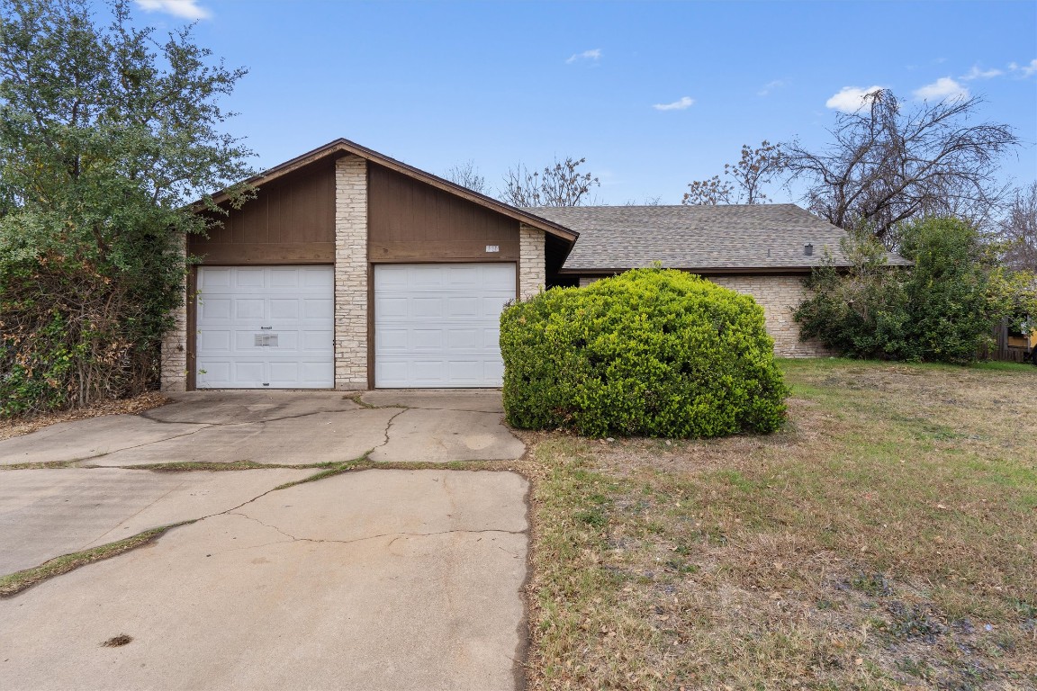 5304 Indio Circle, Unit B Austin, TX 78745 - Photo 1 of 27 a view of a house with a yard and garage