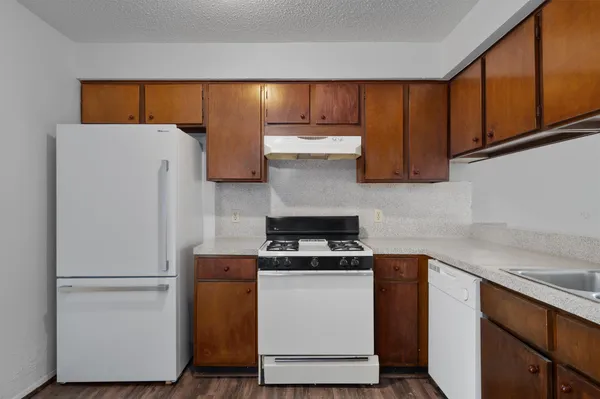 a kitchen with a refrigerator and cabinets