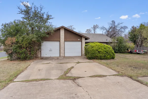 a view of a house with a yard and garage