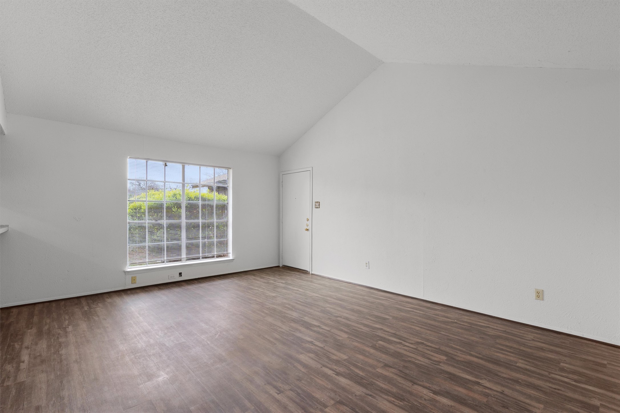 5304 Indio Circle, Unit B Austin, TX 78745 - Photo 6 of 27 an empty room with wooden floor and windows