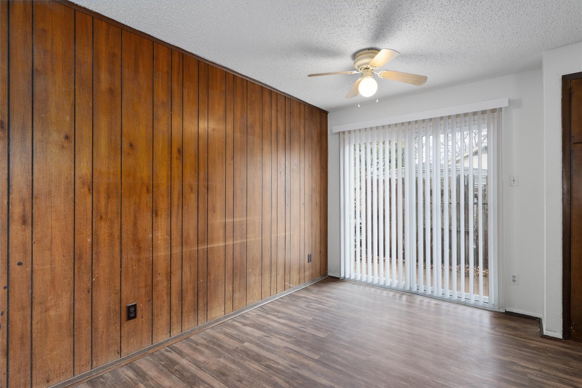 5304 Indio Circle, Unit B Austin, TX 78745 - Photo 9 of 27 an empty room with wooden floor fan and windows